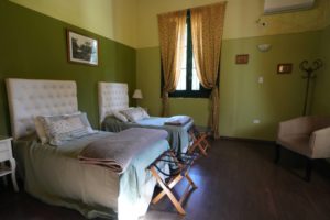 Guest bedroom with private bath at the 1840 estancia hunting lodge